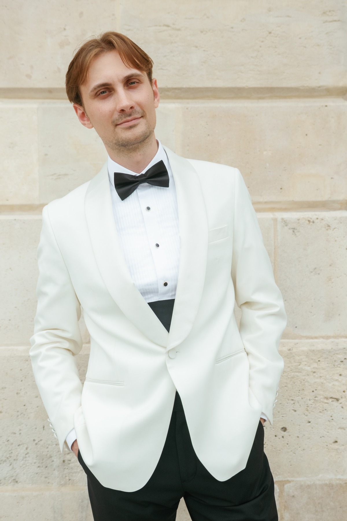 groom in white dinner jacket and black tie