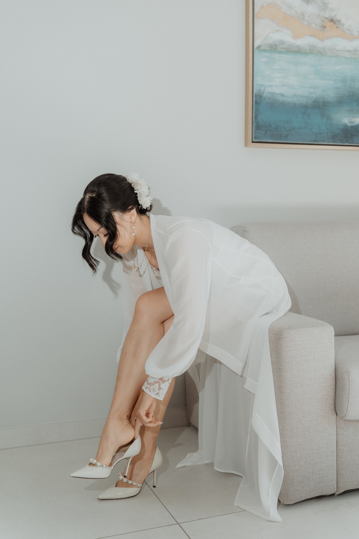bride putting her shoes on