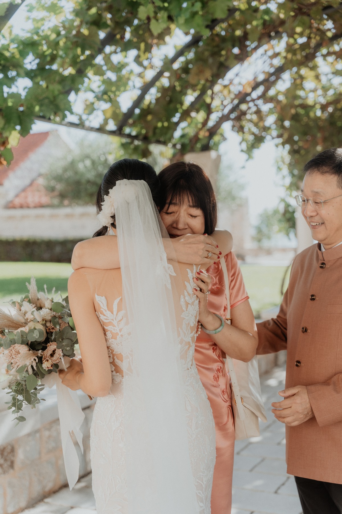 bride with parents getting ready