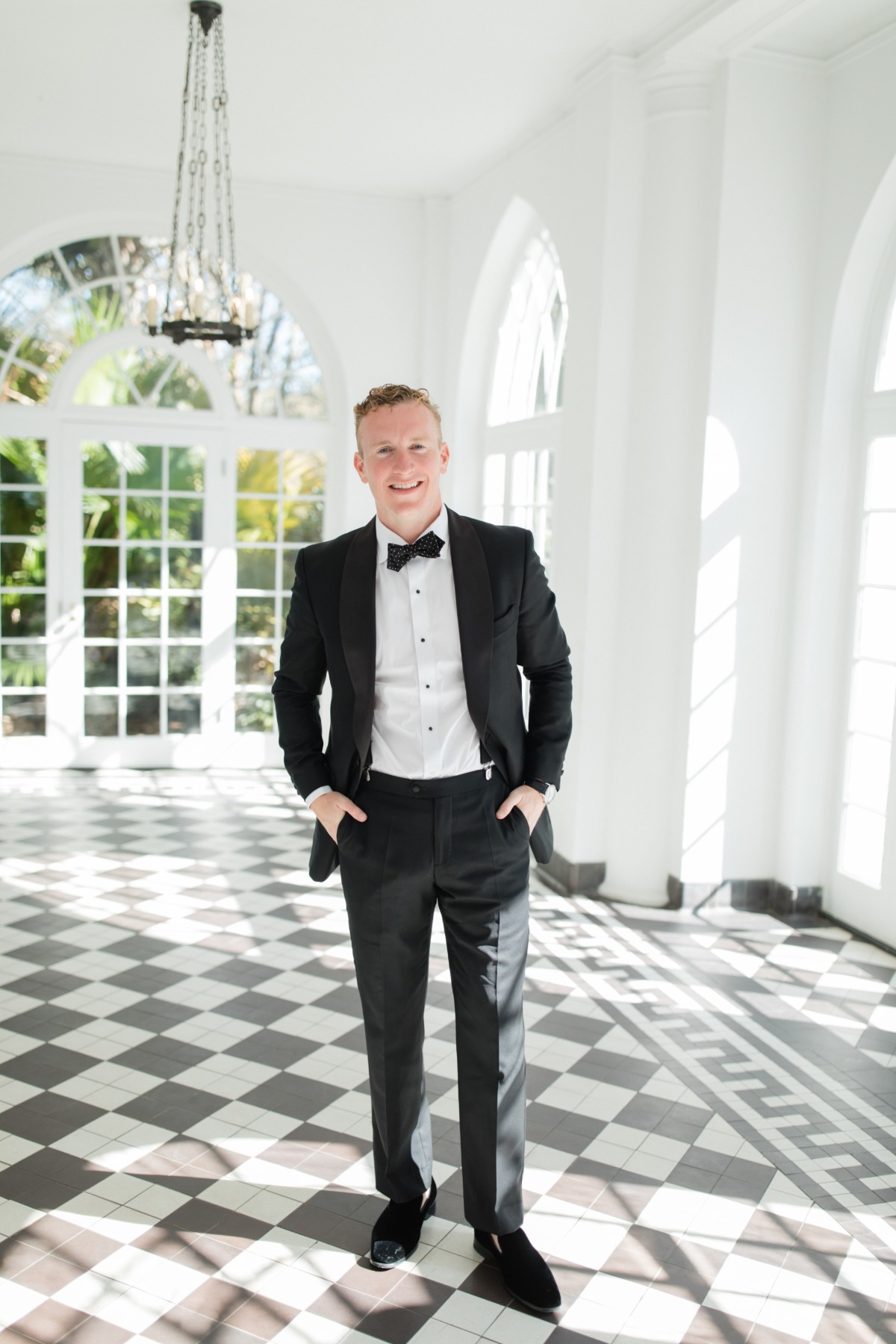 groom in black tux