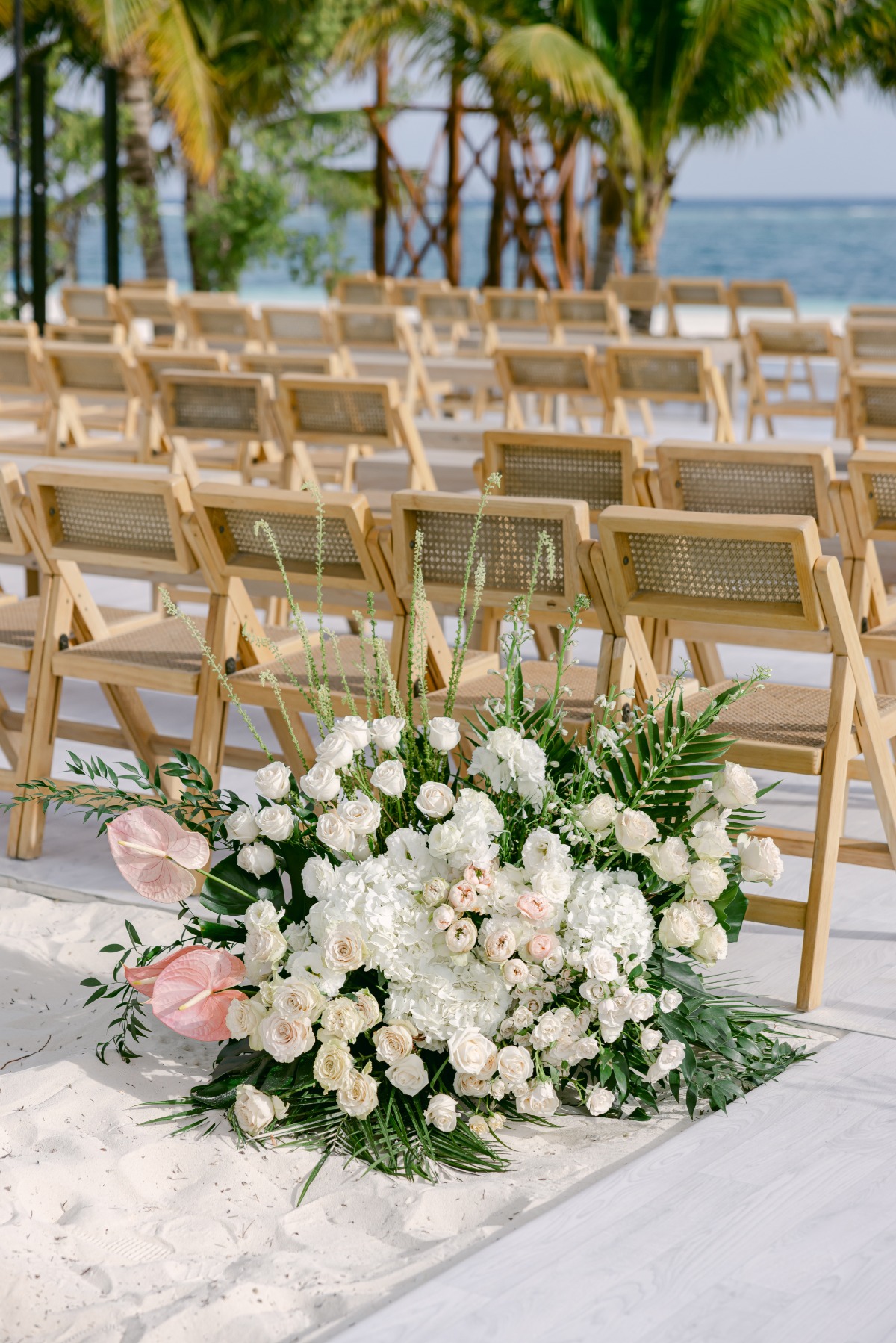 pink, white, and tropical greenery floral arrangements