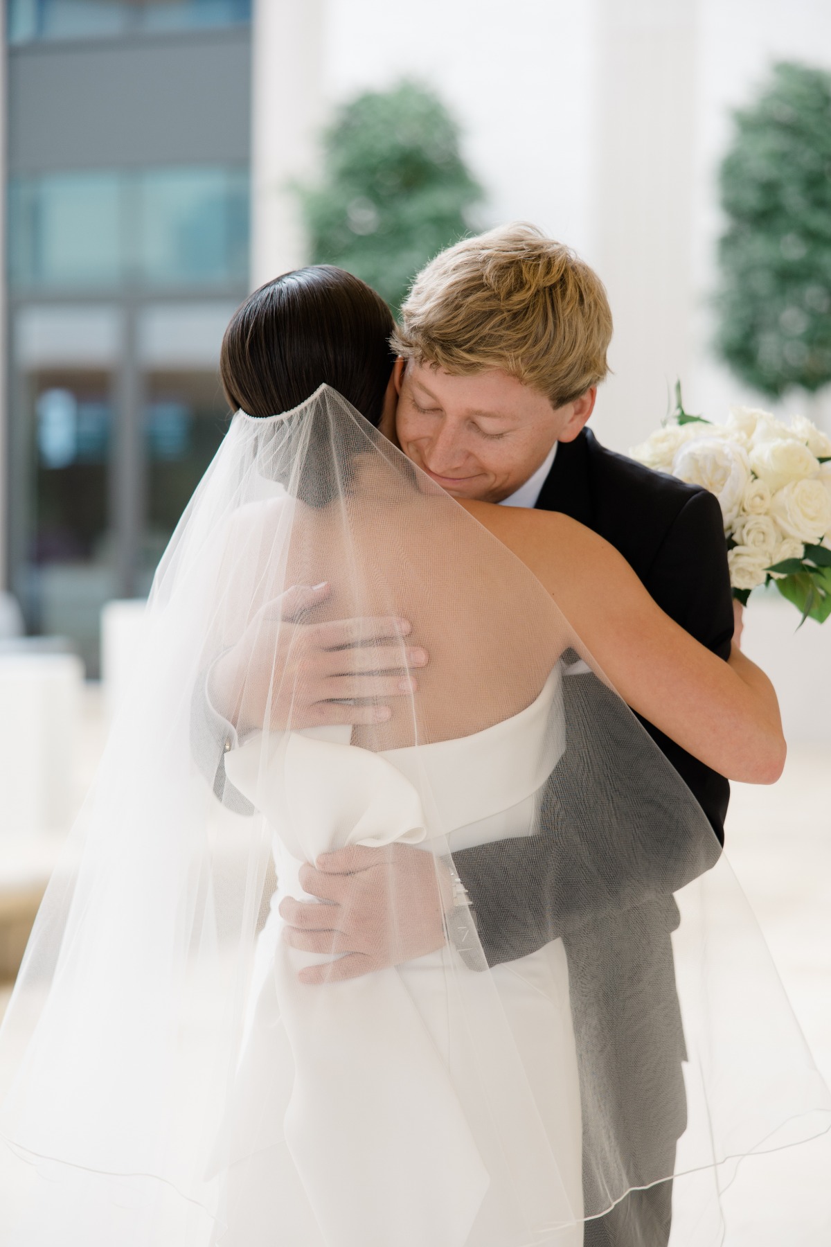 hug after first look for wedding photos