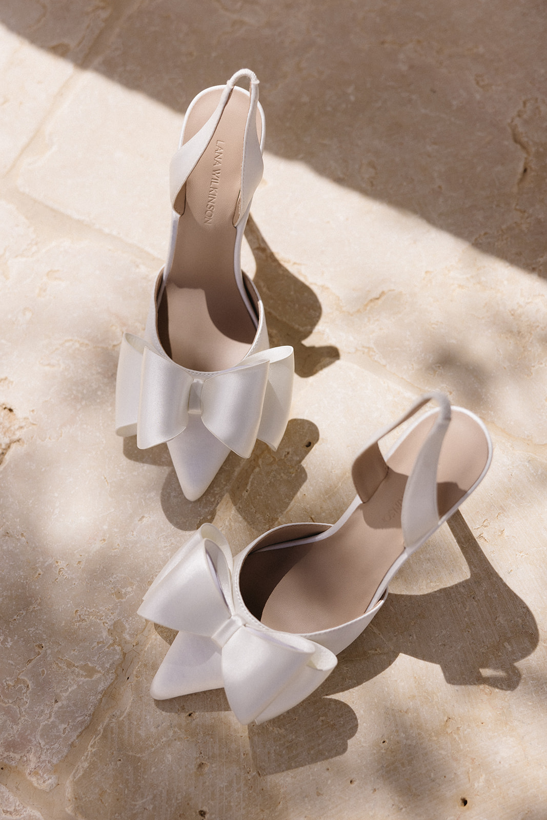 white satin pumps with bows paired with galia lahav remi gown