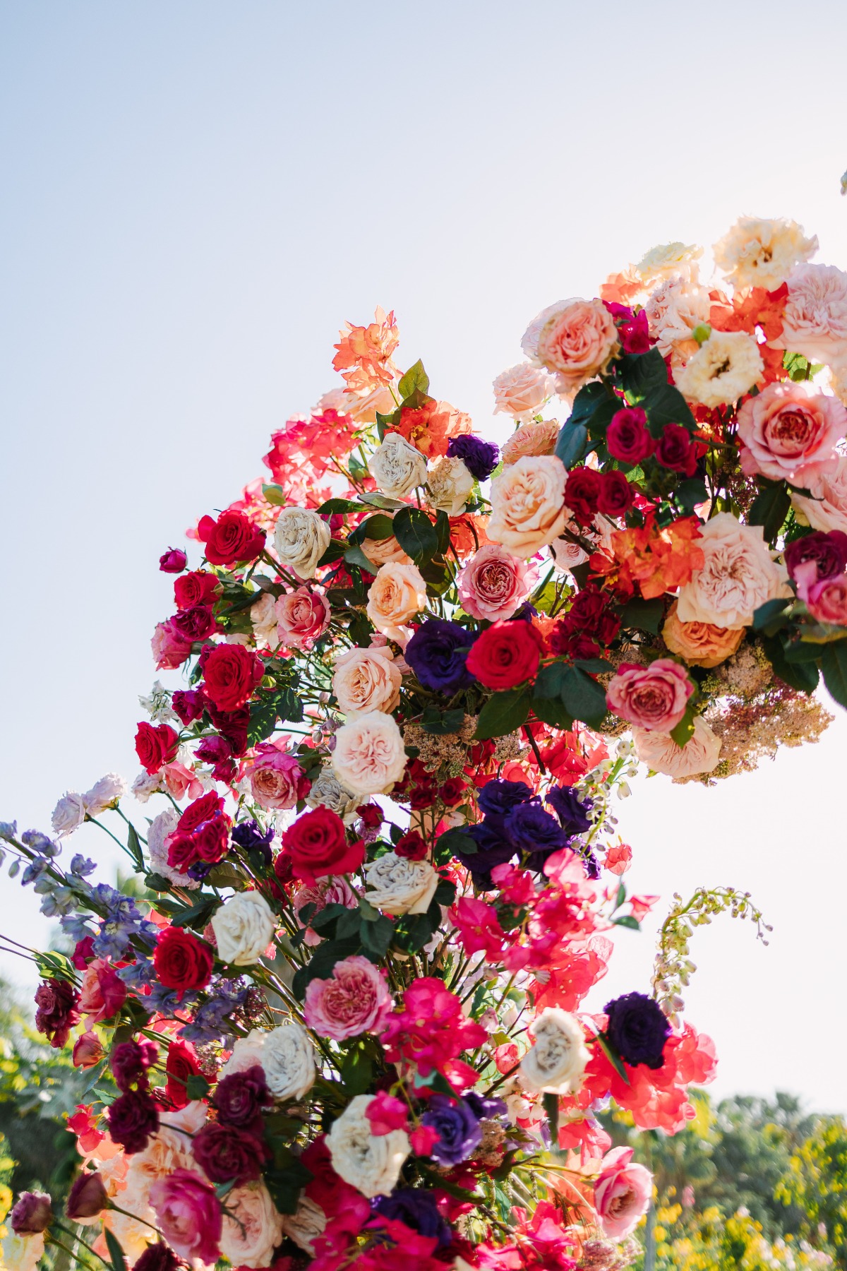 colorful rose floral arch for wedding ceremony