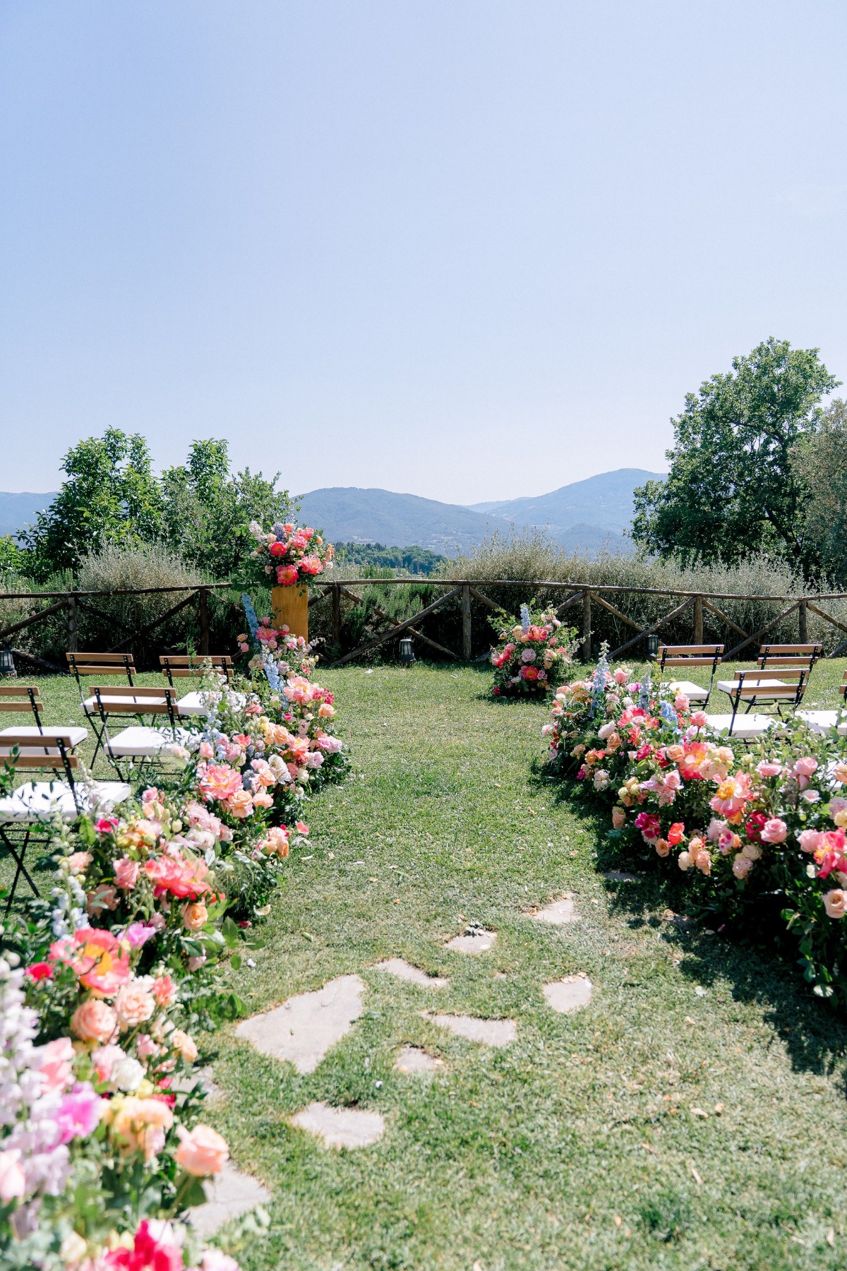 colorful rainbow wedding ceremony aisle floral arrangements