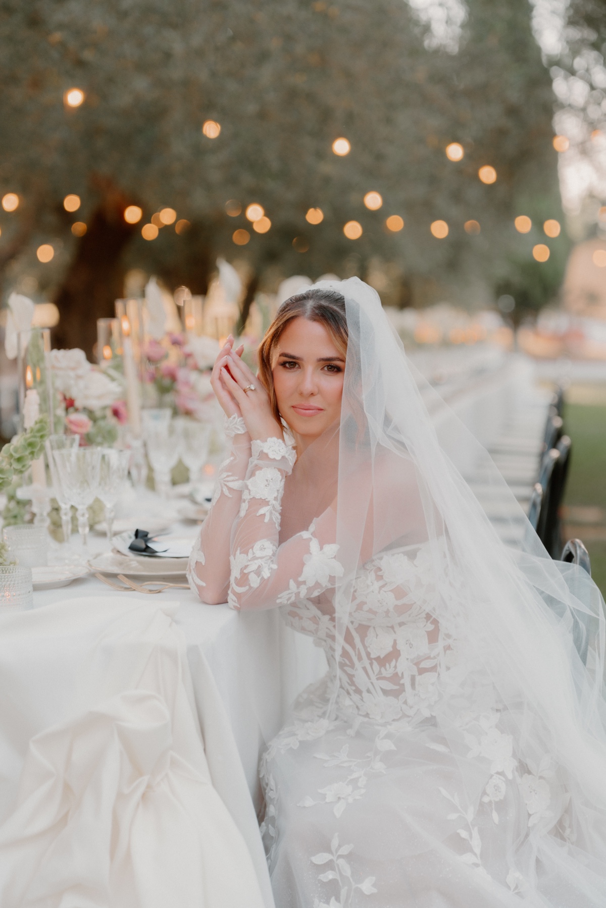 bride sitting at outdoor reception table