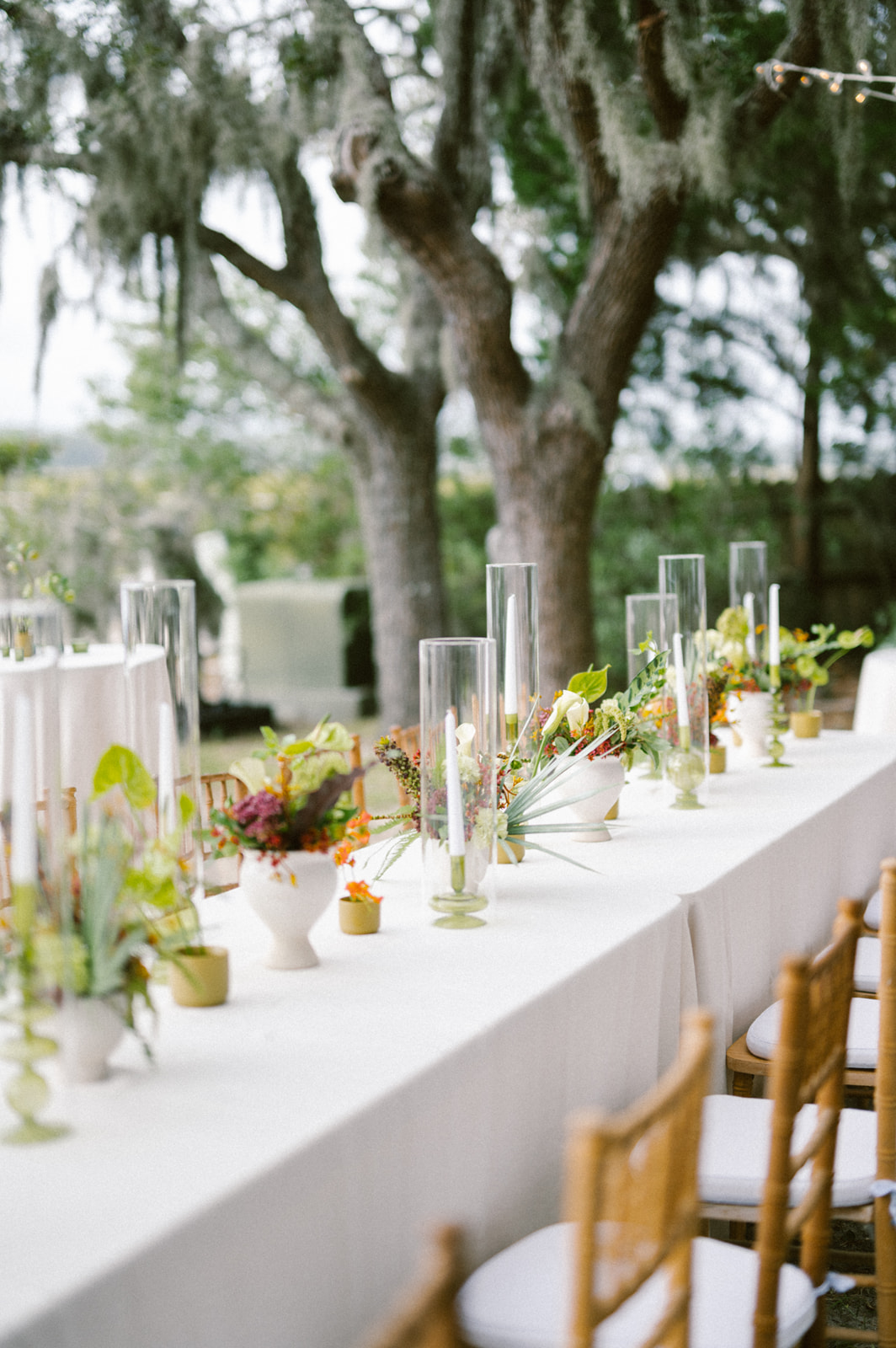 tall votives with tropical inspired flowers