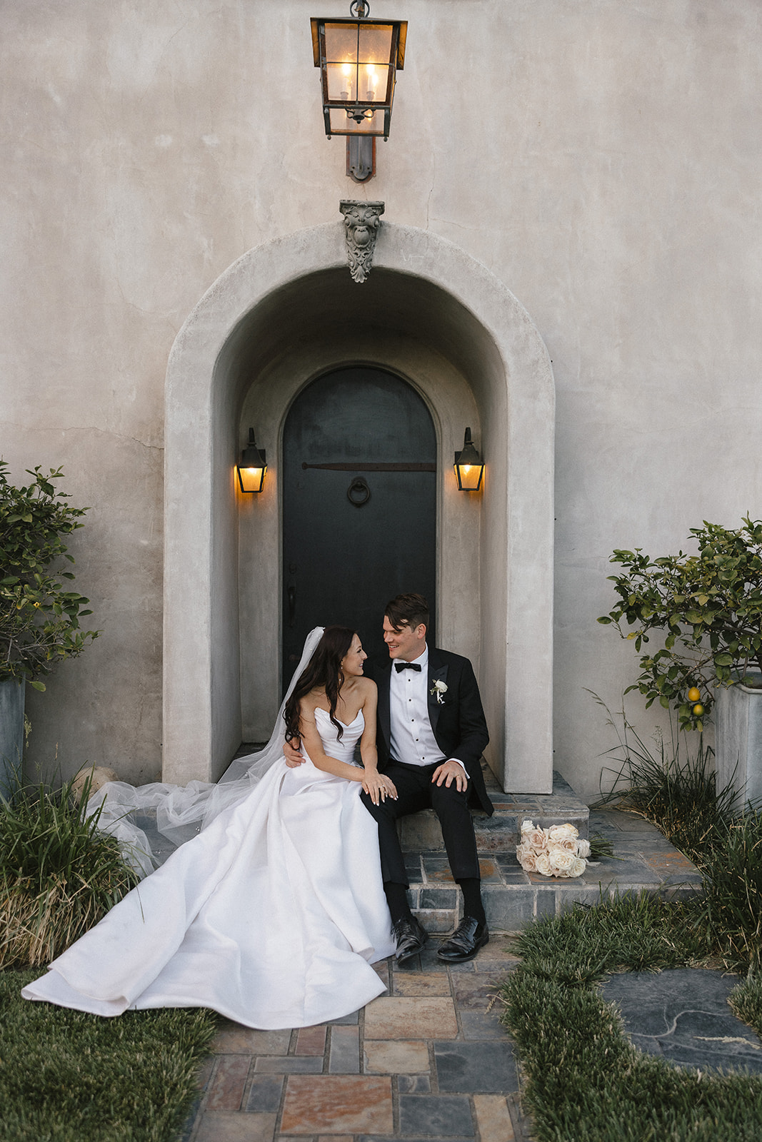 couple sitting in front of wedding venue