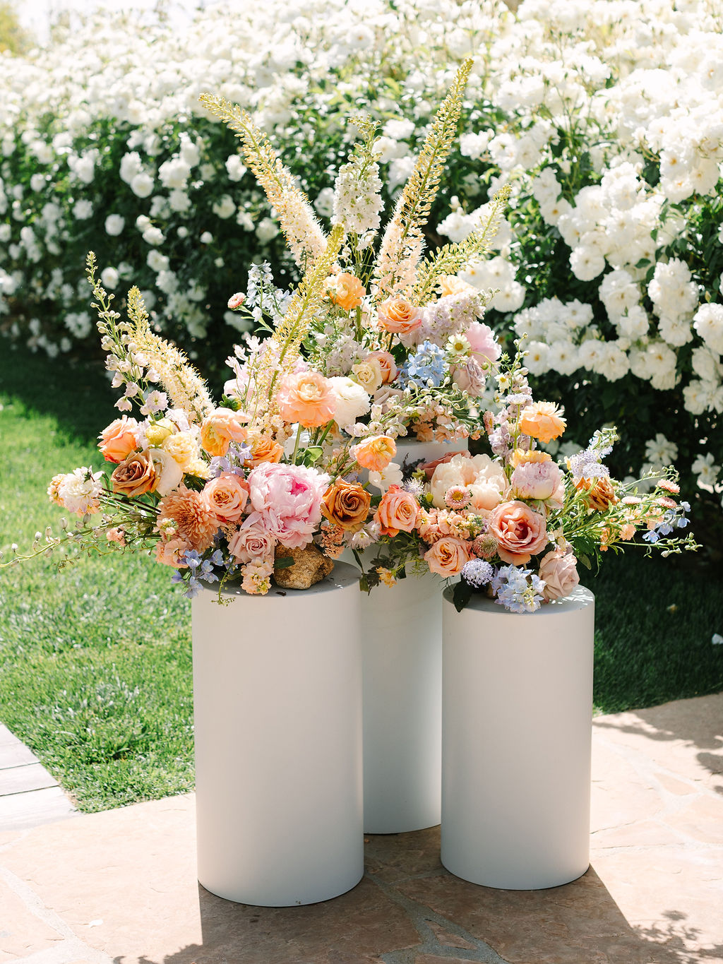 pastel floral arrangements on pedestals
