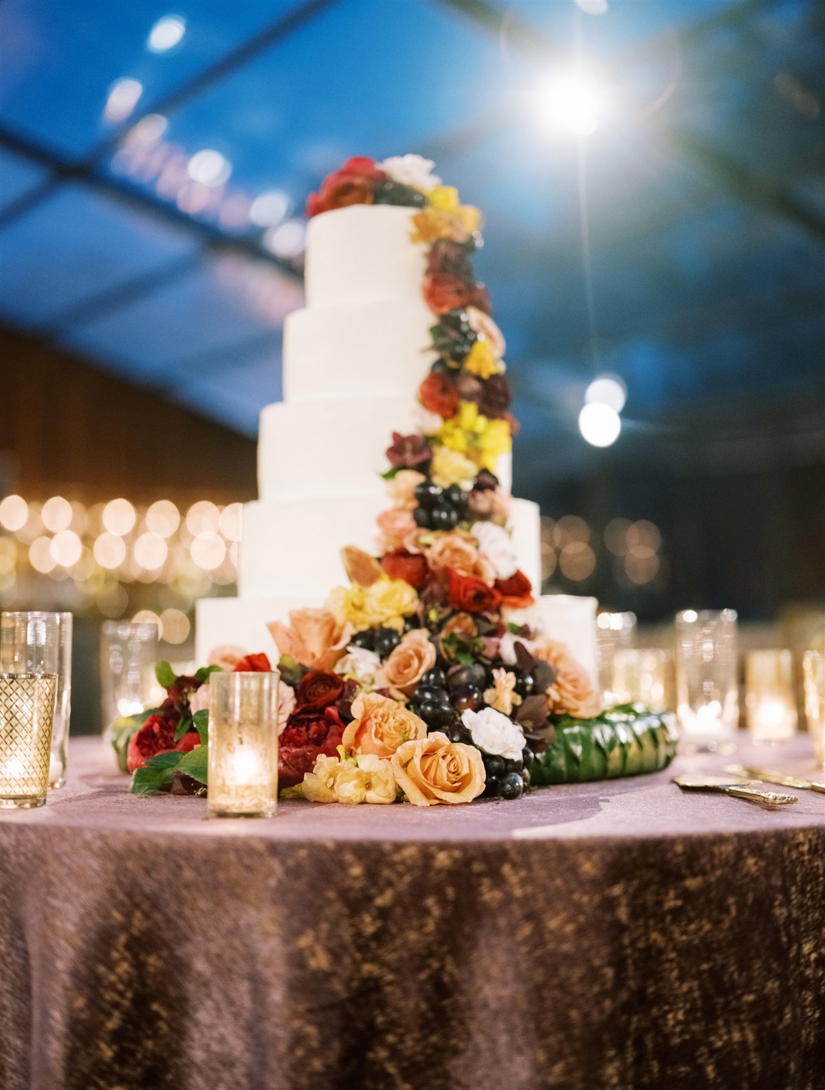 fresh flowers and grapes on wedding cake