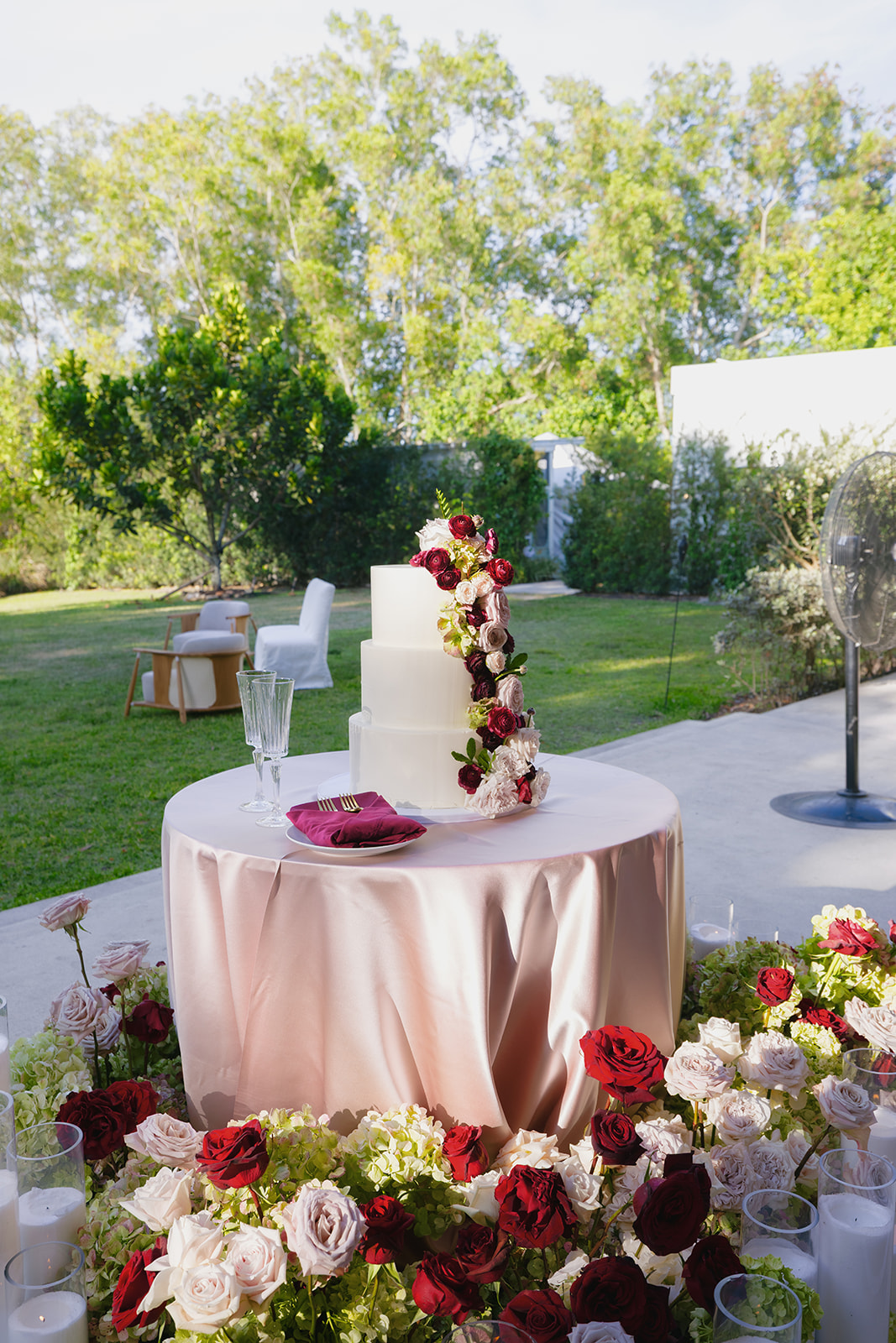 three tiered wedding cake with fresh flowers
