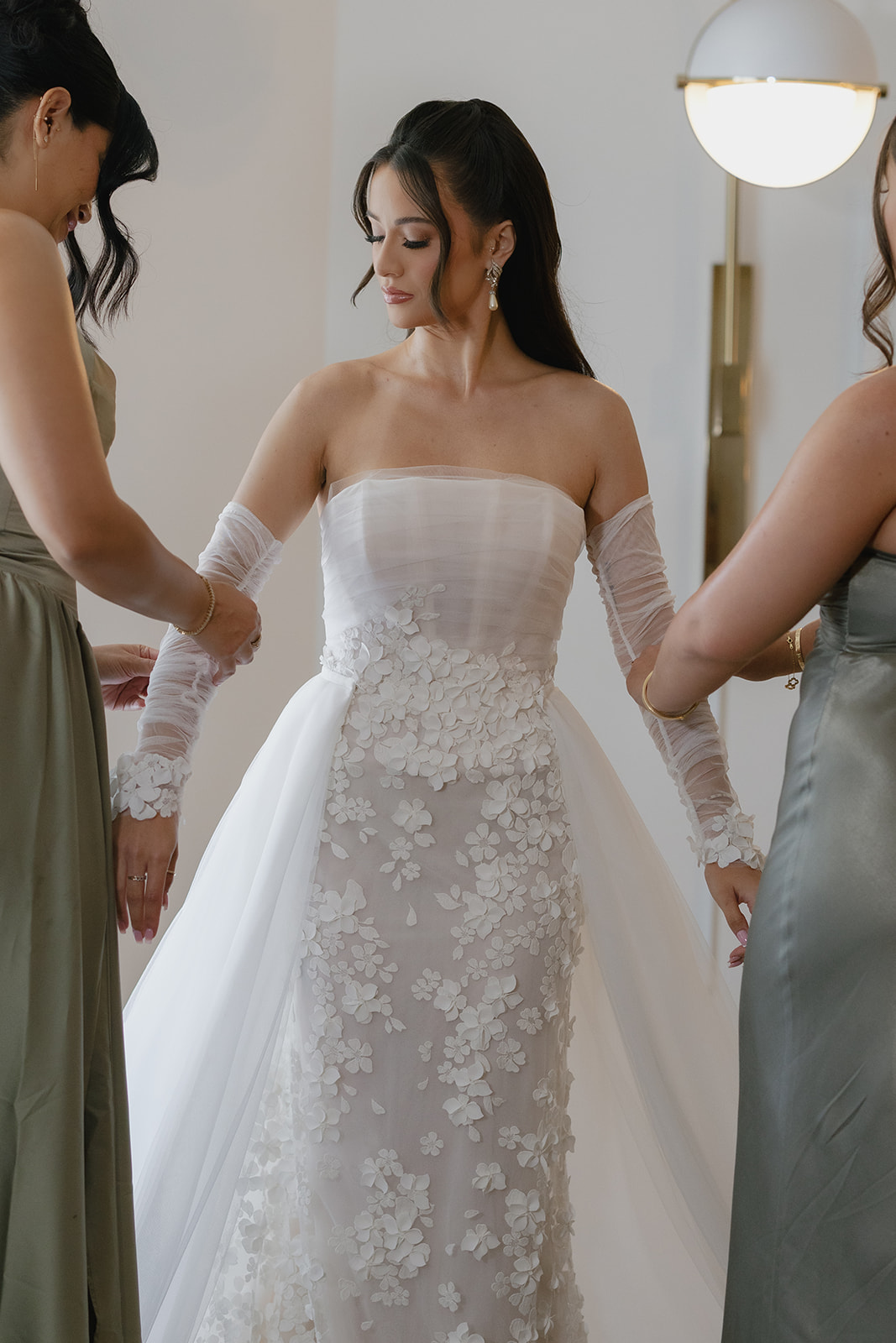 bridesmaids helping bride get ready