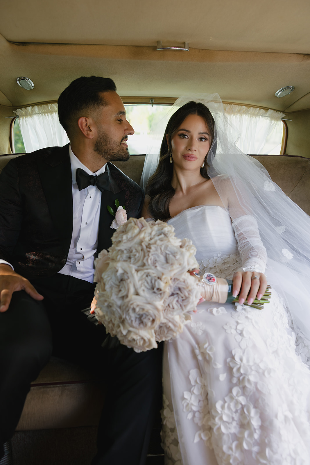 bride and groom in vintage car