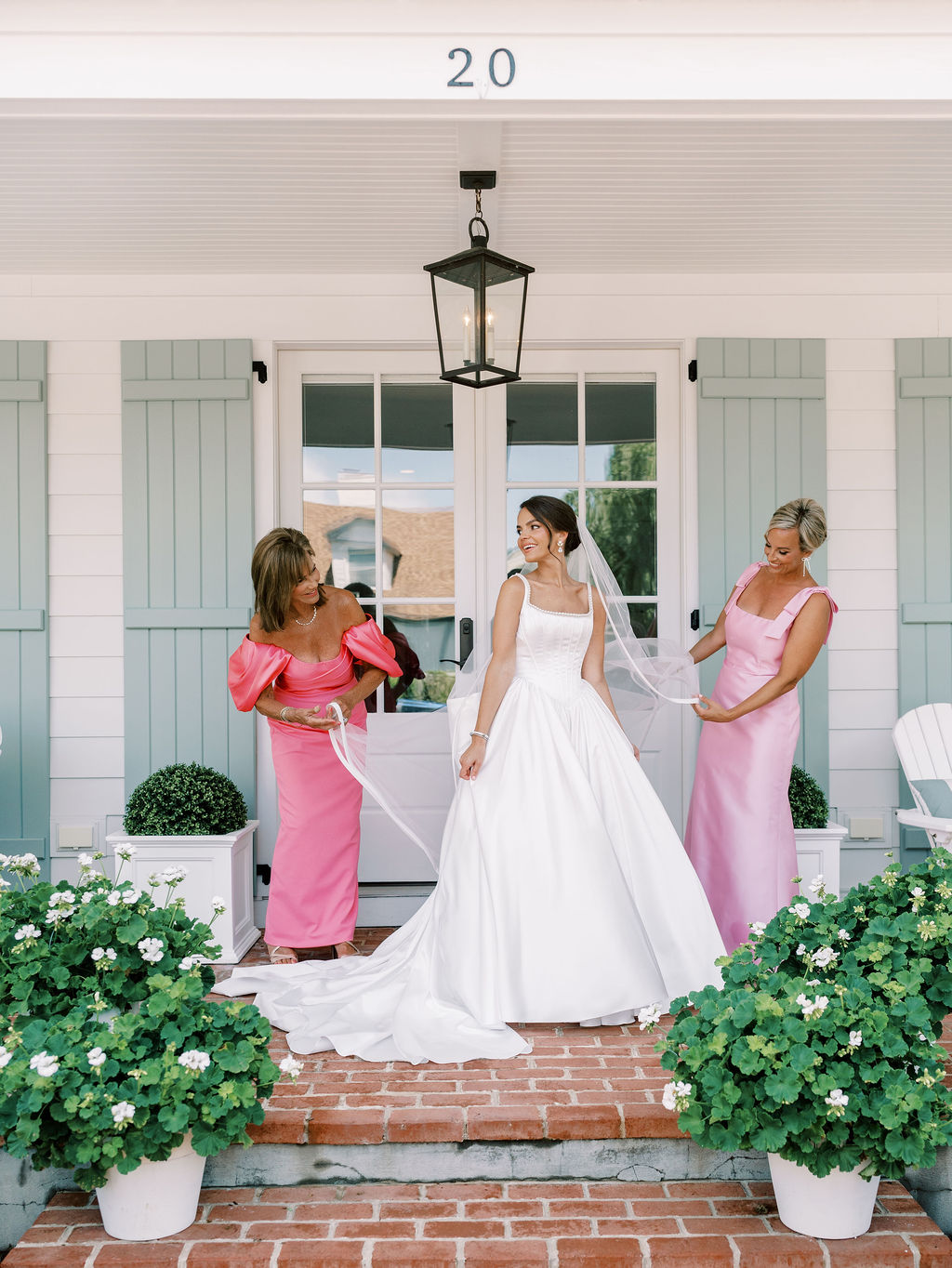 mother of the bride and maid of honor helping bride