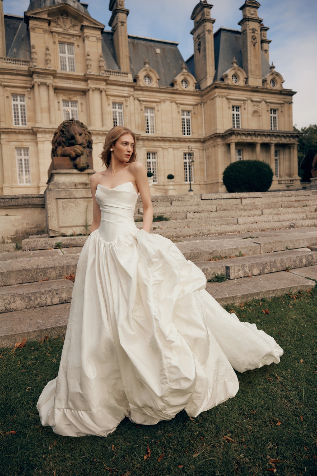 bride ins gown in front of castle