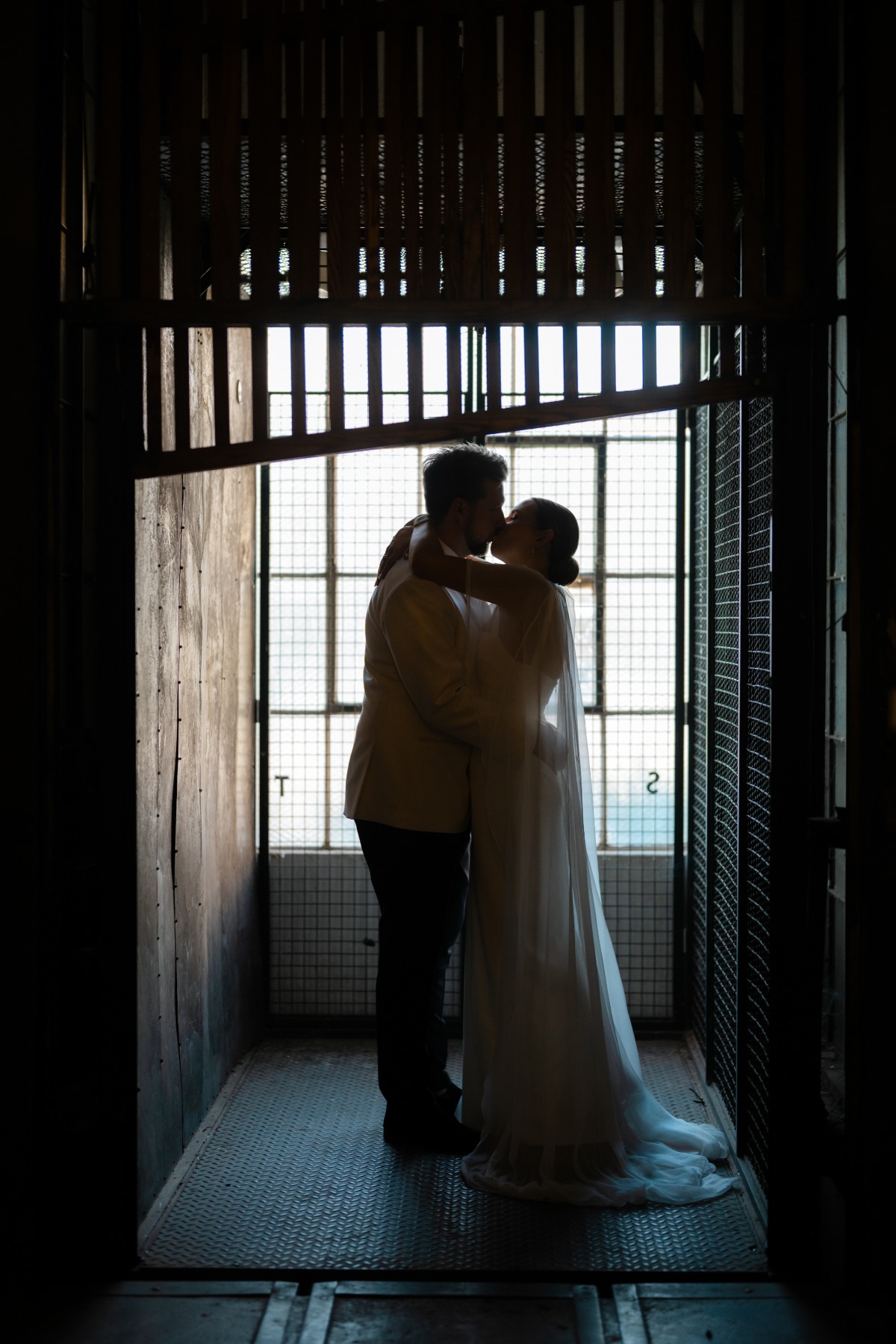 wedding couple kissing in dark room