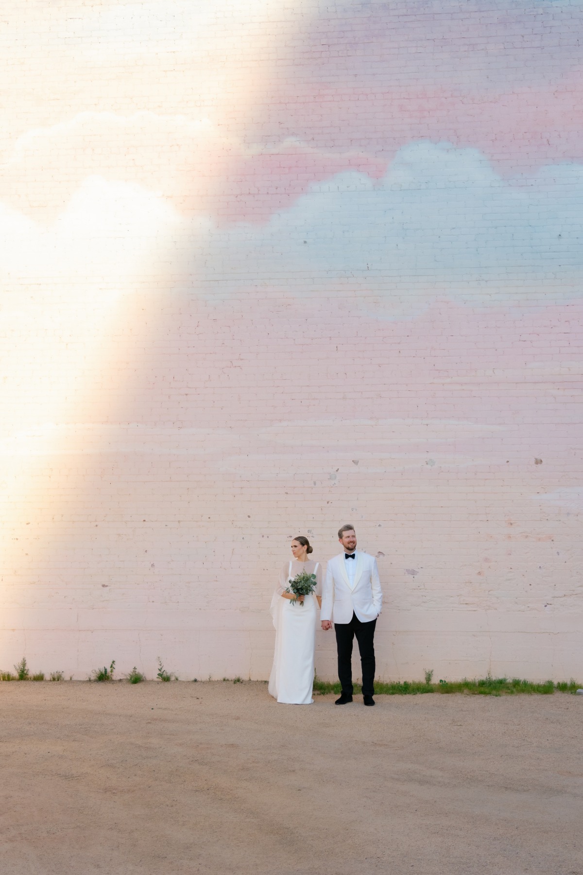 couple in front of mural