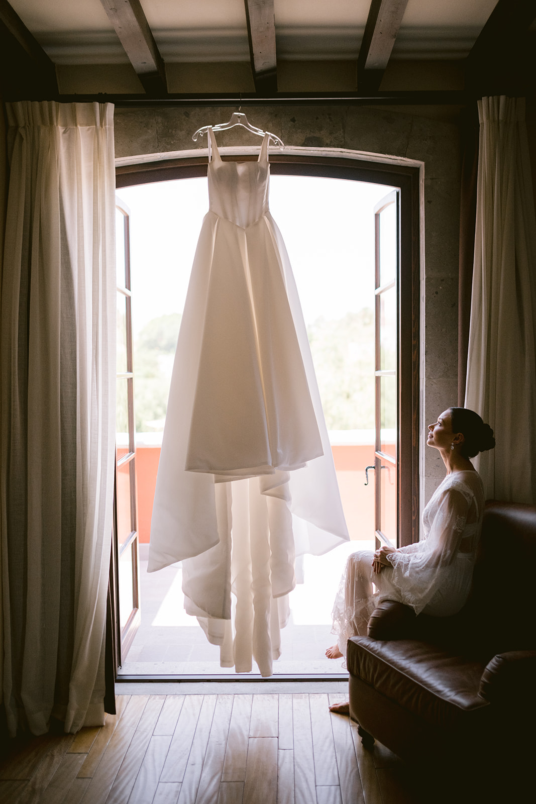 bride looking at galia lahav gown