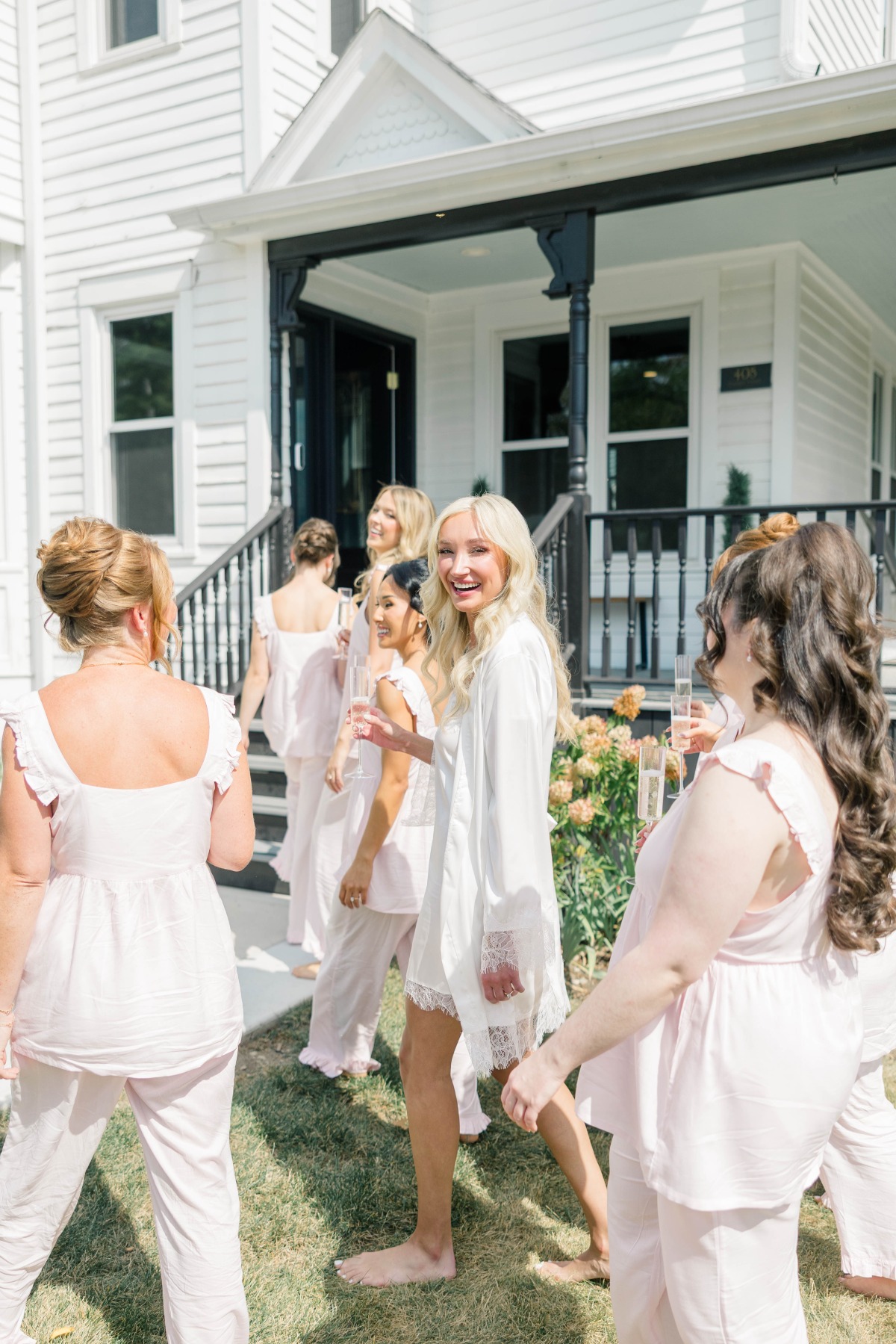 bride in robe and bridesmaids in pink pajamas