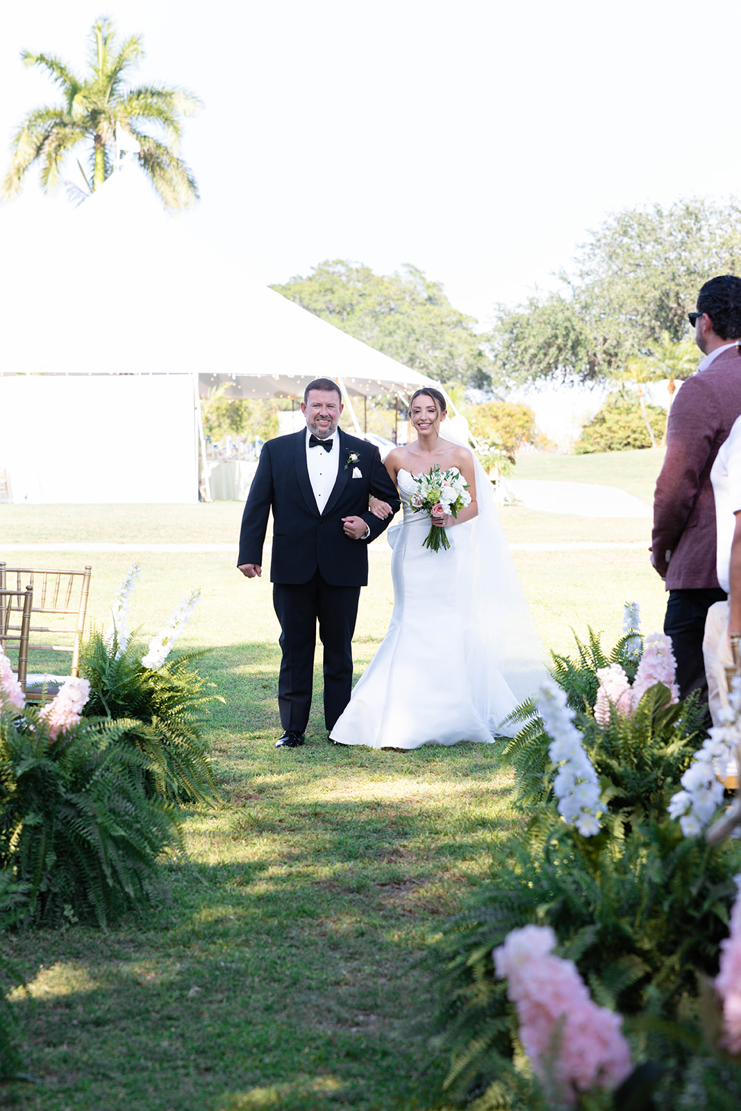 father walking bride down the aisle on golf course