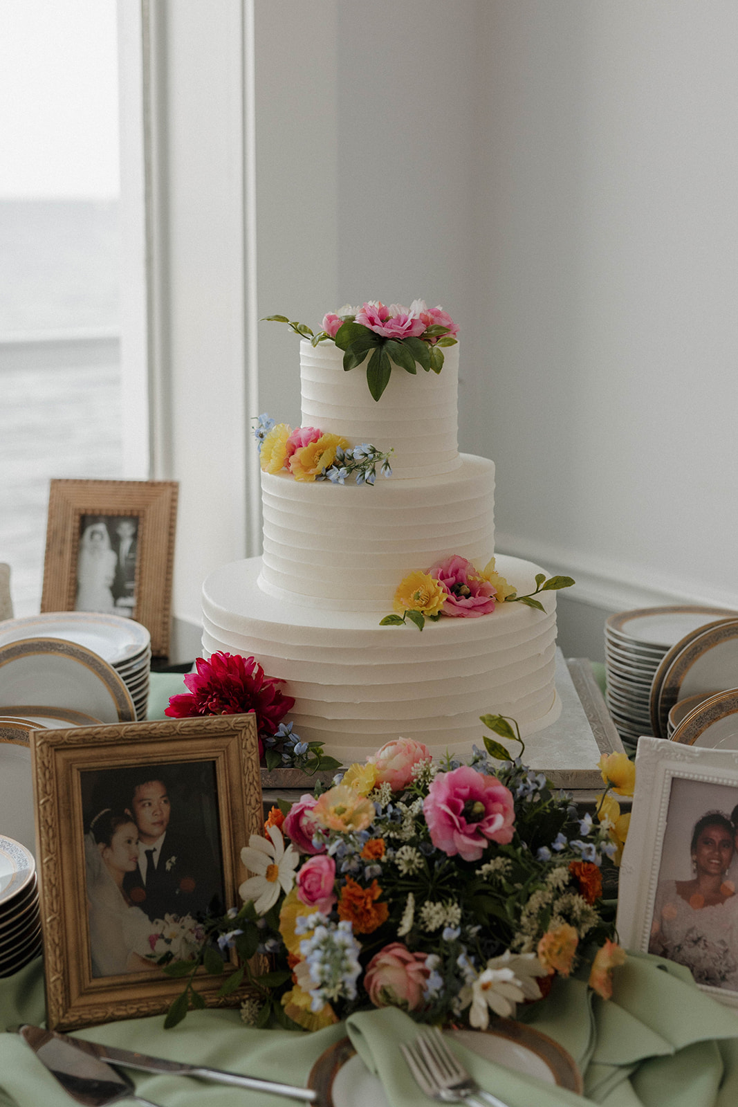 white wedding cake with colorful flowers