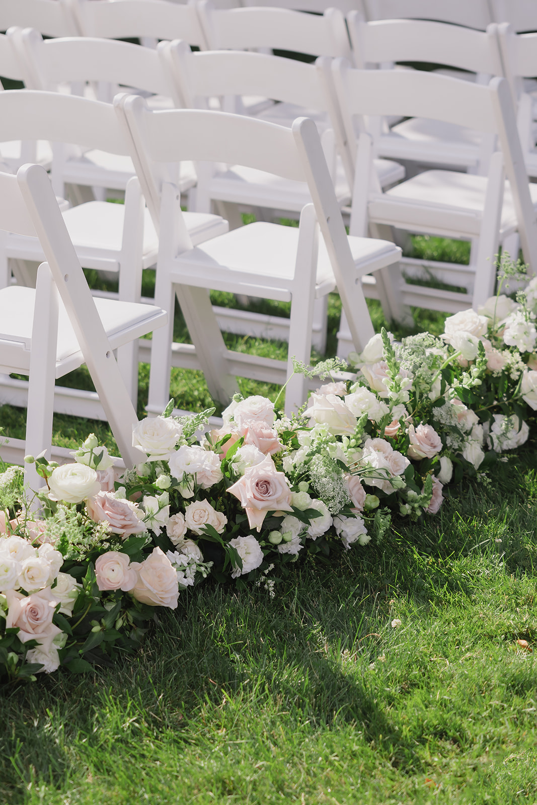 blush and ivory rose arrangements lining the aisle