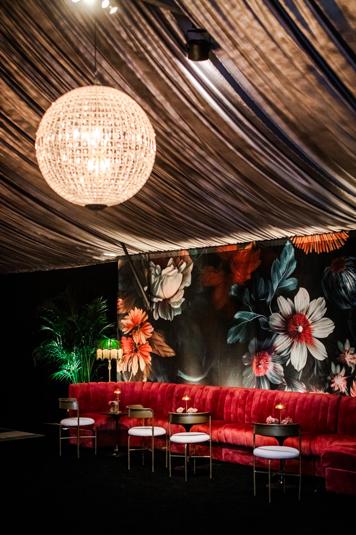 dark reception space with tropical floral wallpaper