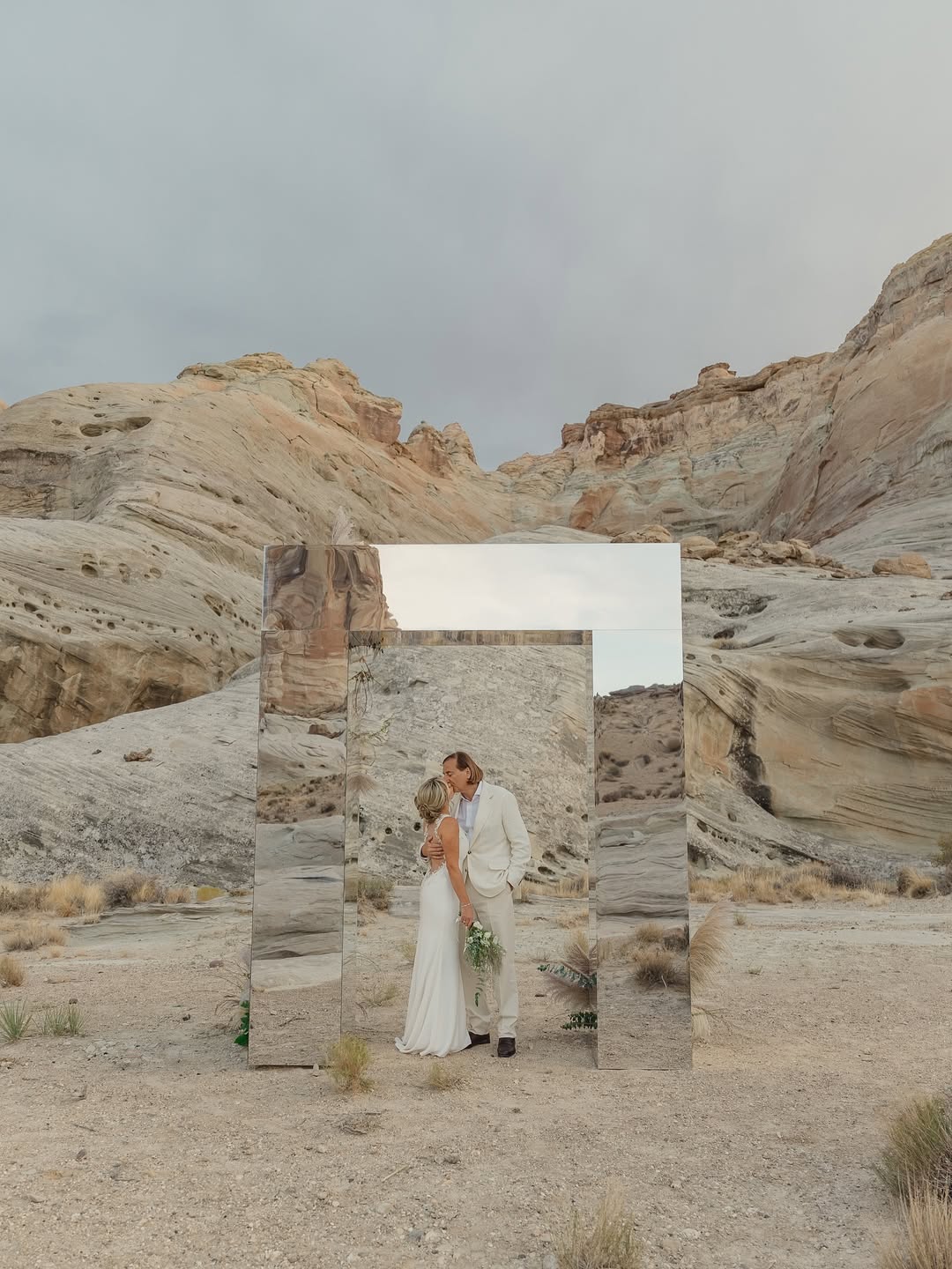 couple in utah desert in front of mirrored wall