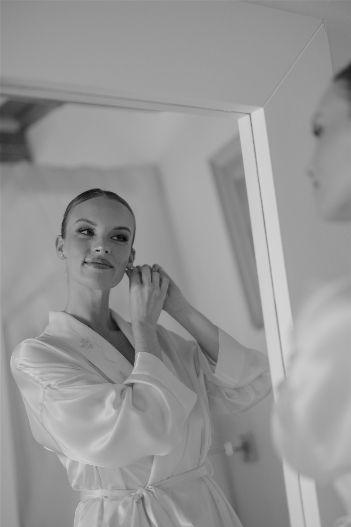 bride putting on earrings