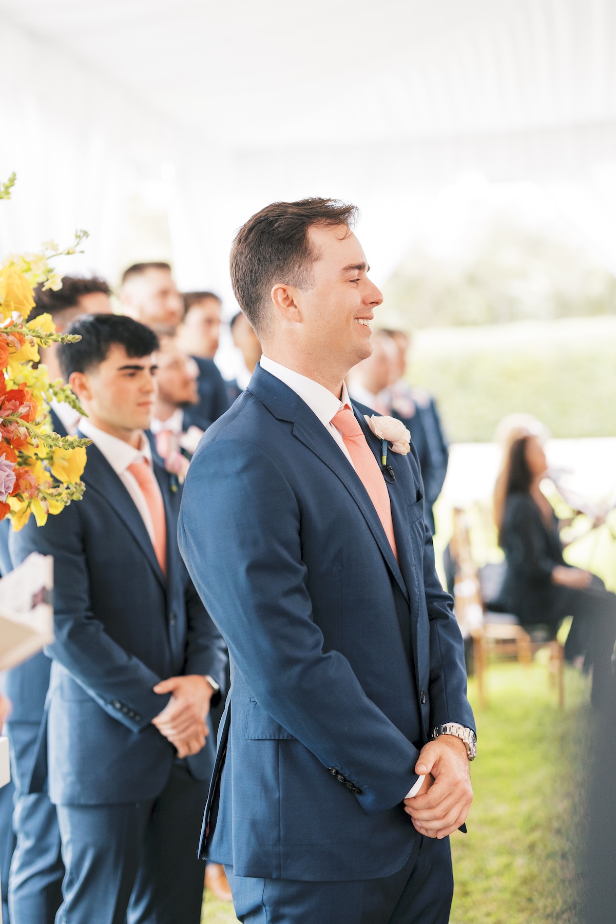groom in blue suit with pink tie