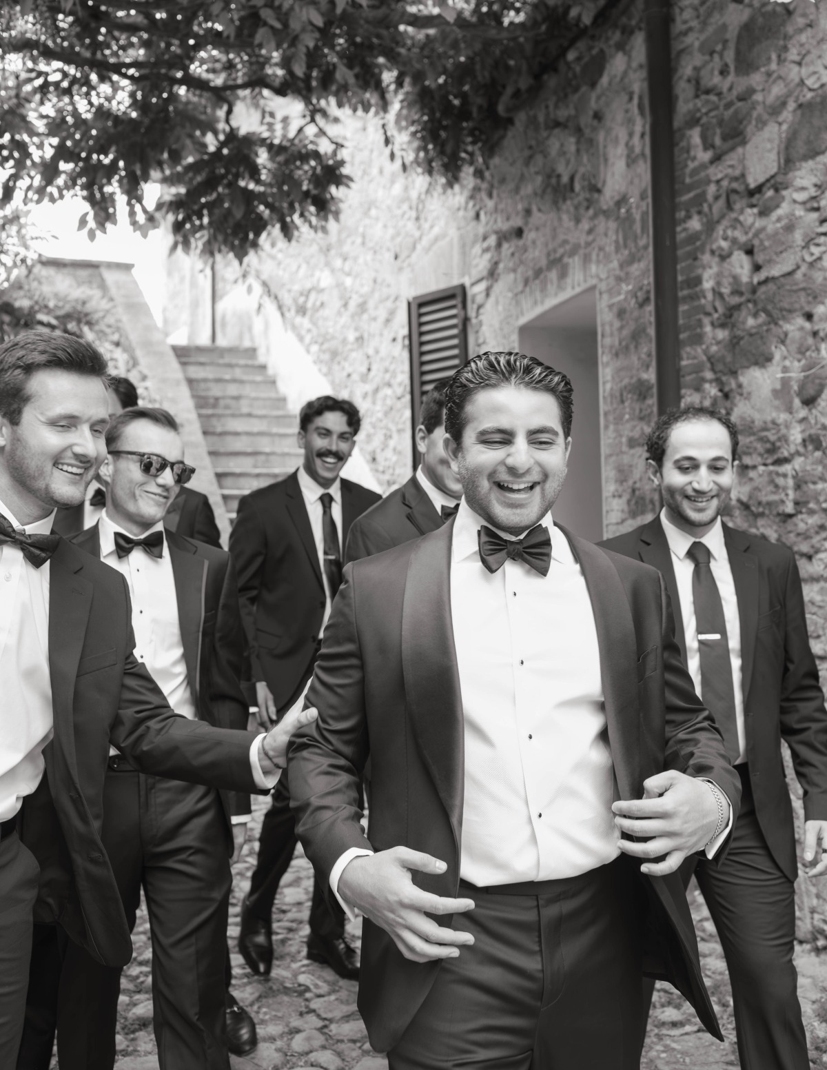 groom and groomsmen walking at a castle