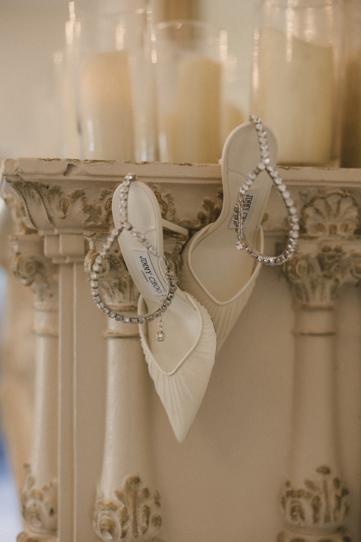 jimmy choo bridal shoes hanging on vintage shelf