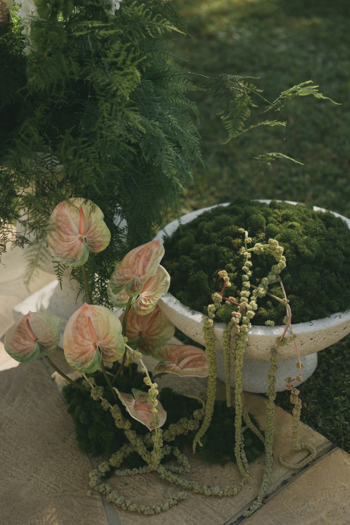 green and pink calla lilly in a cement pot, unique wedding decor highlight