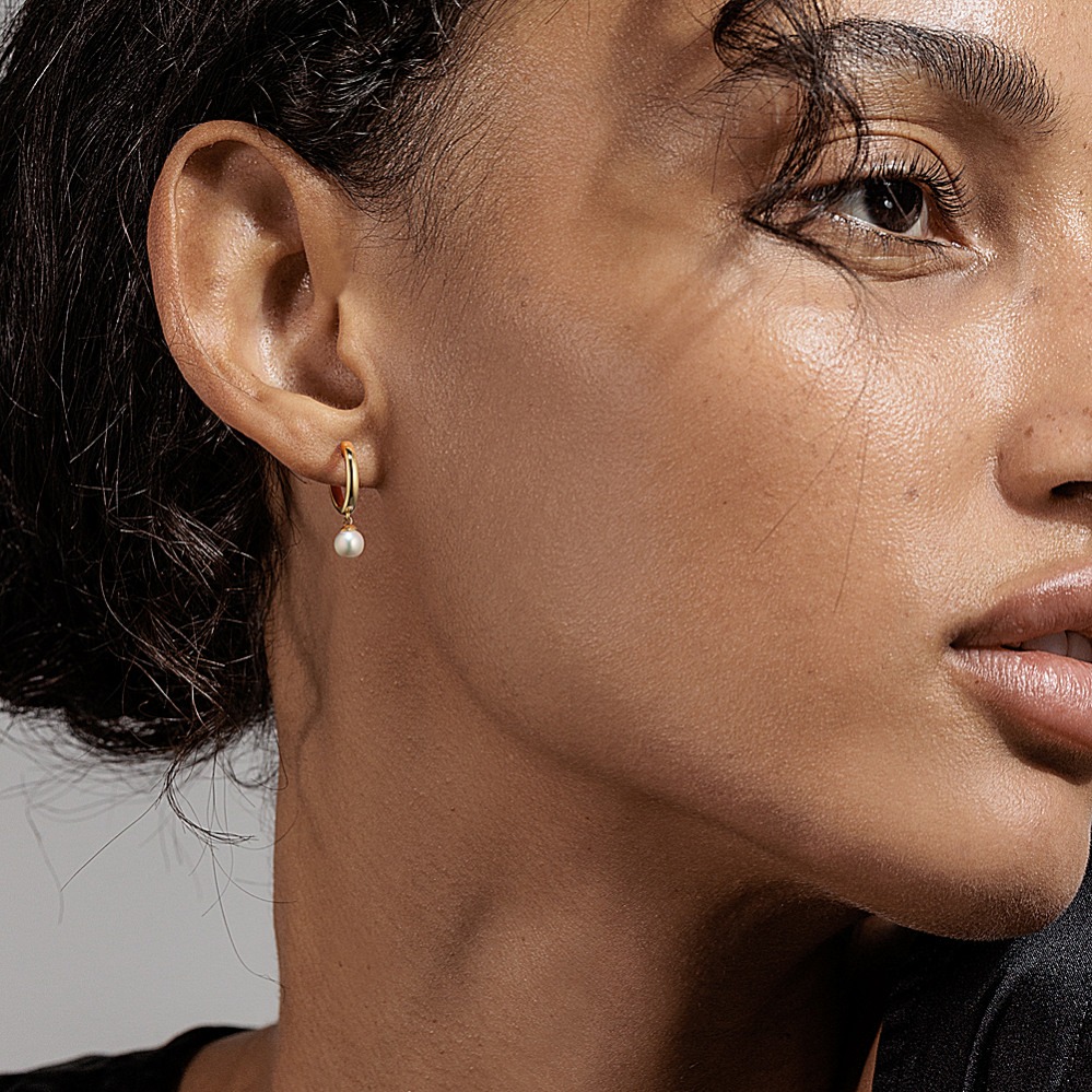 gold and pearl huggie hoops from shane co