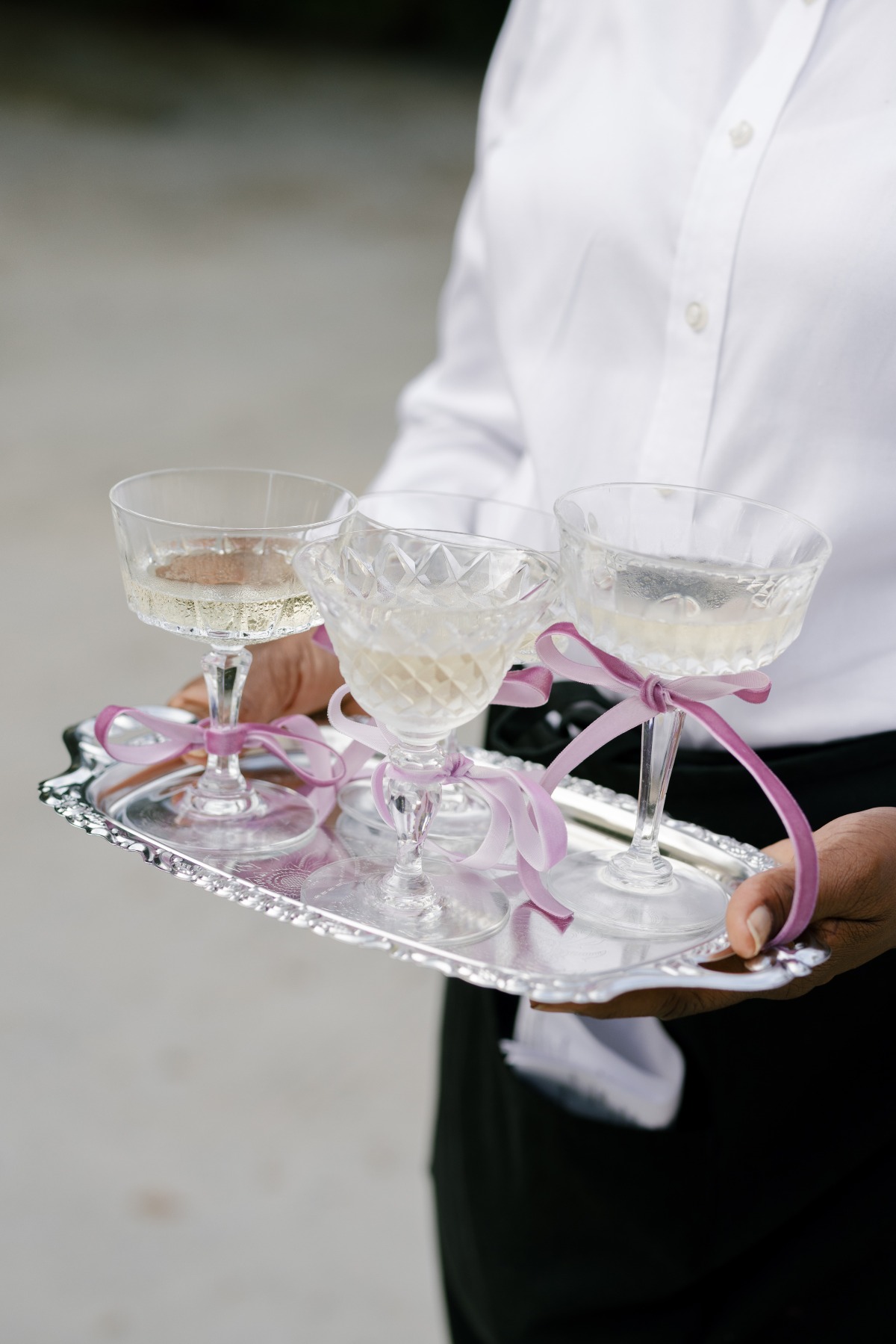 server holding tray of wedding cocktails
