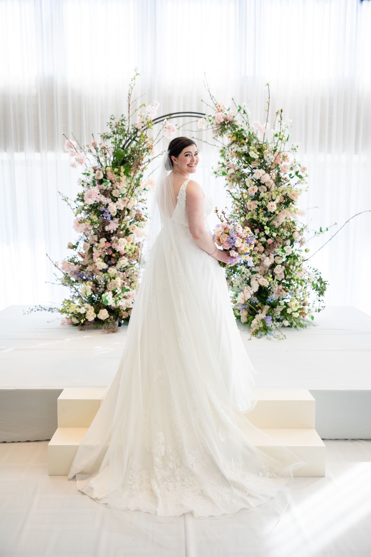 spring bride with floral arch