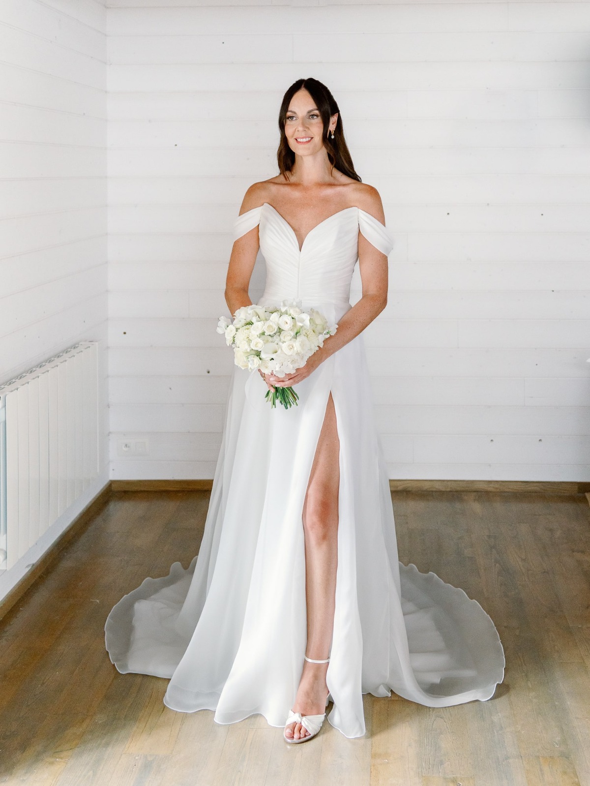 bride in off the shoulder wedding gown with slit