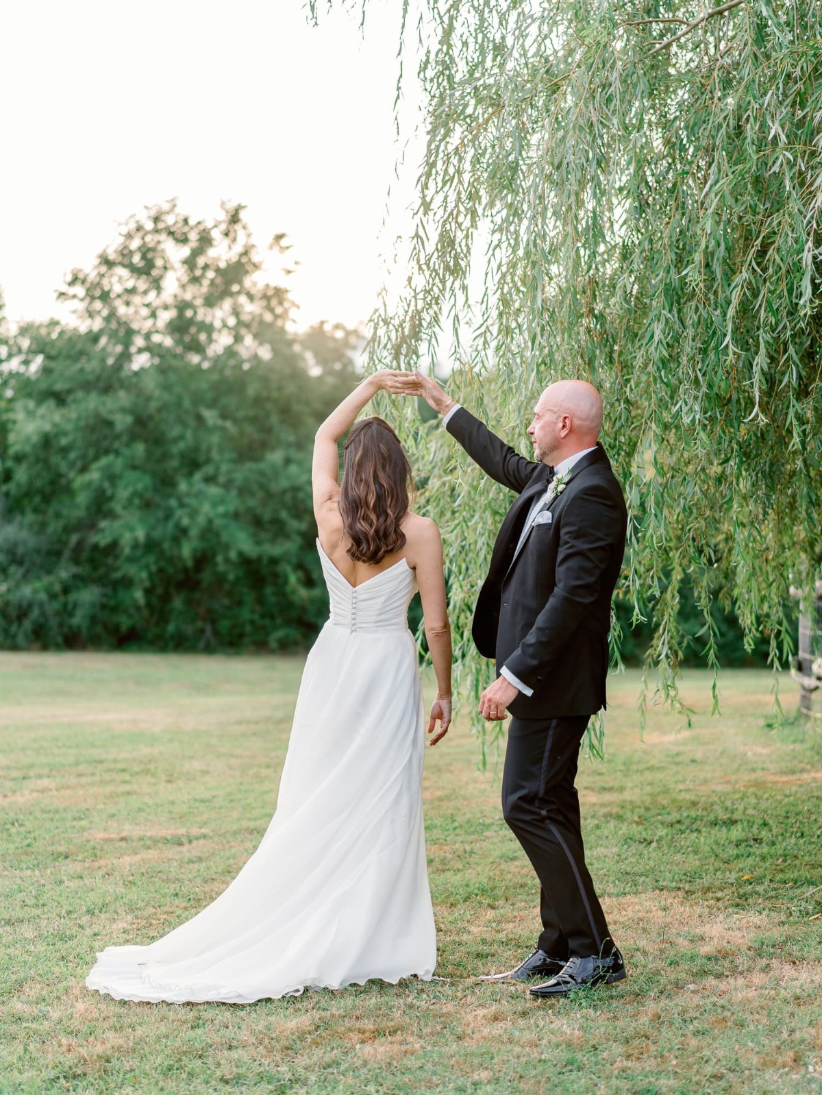 groom twirling bride