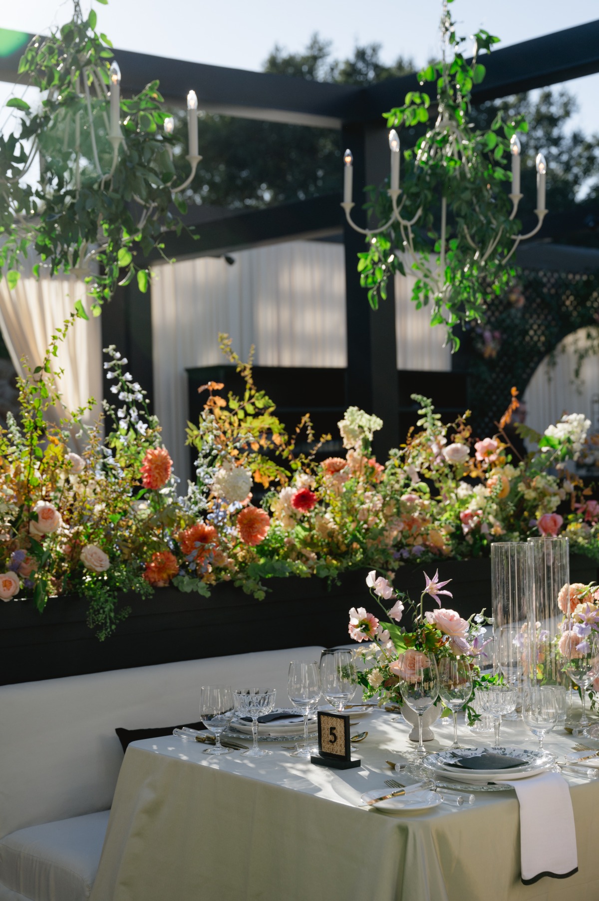 luxury wedding reception space with tons of flowers and black pilars