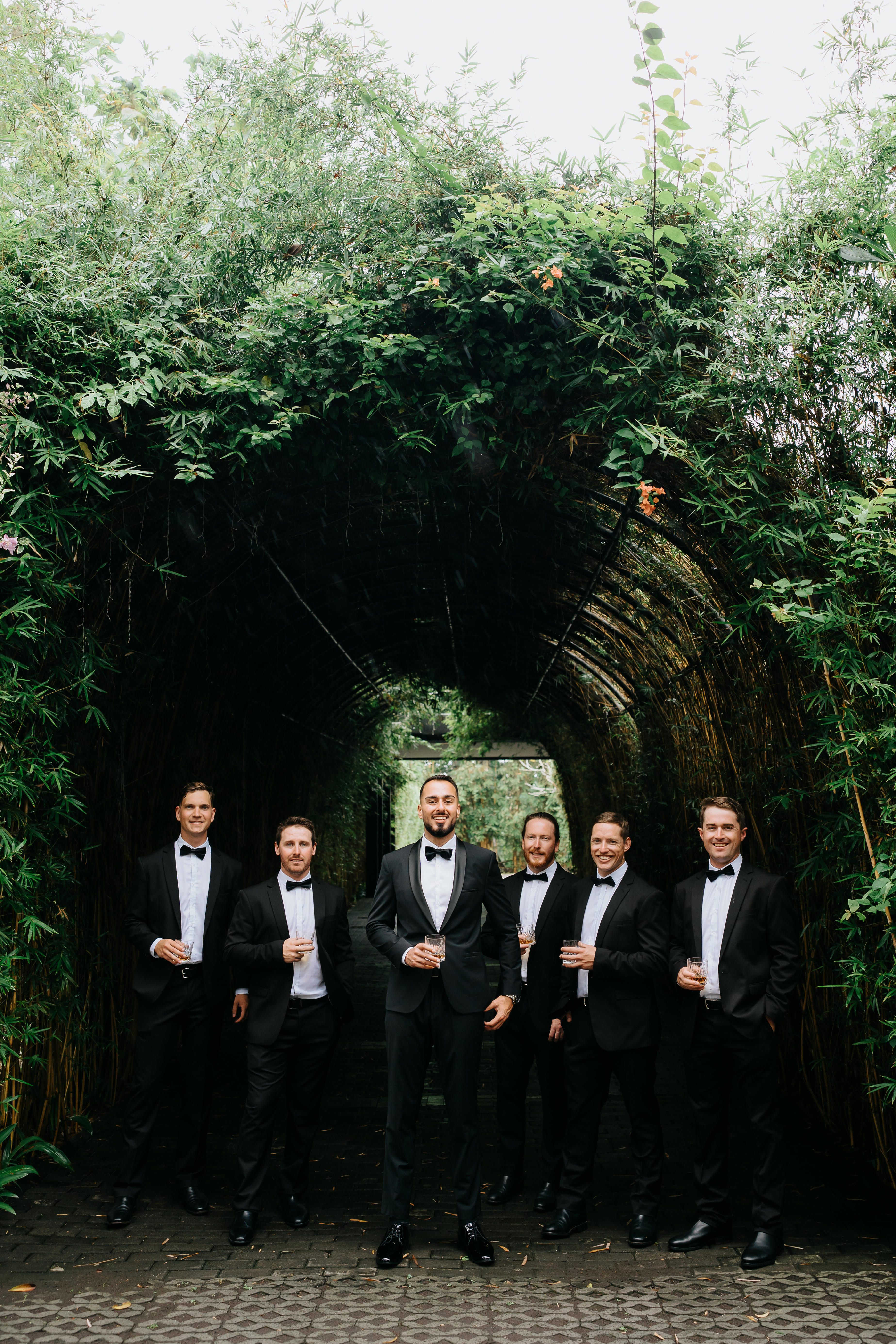 groom and groomsmen in black tuxedos