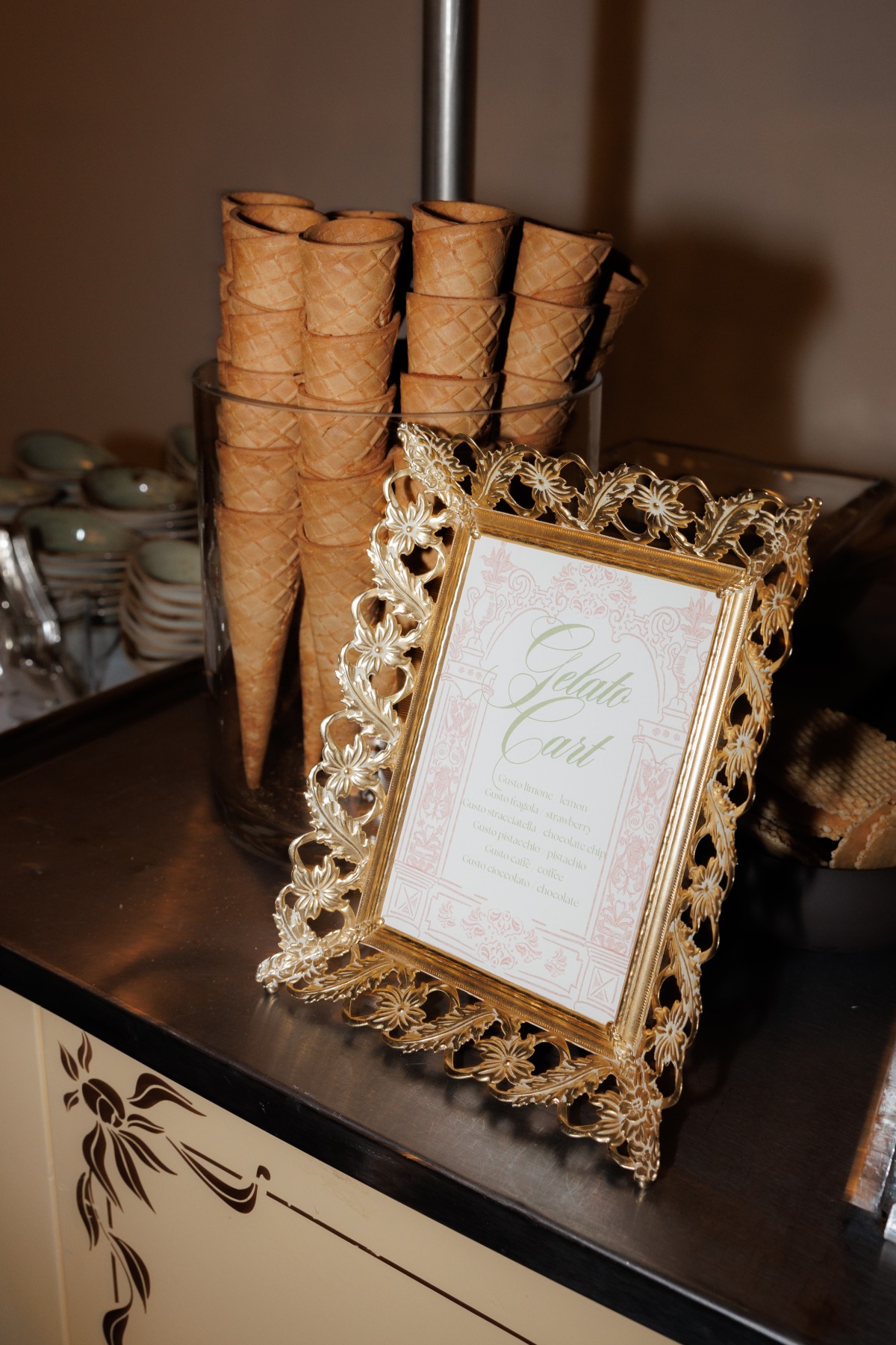 dessert stand at wedding with gelato menu sign and cones