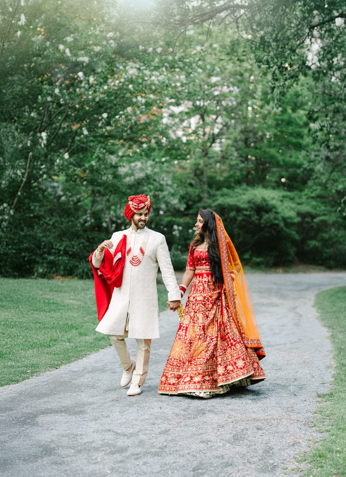 Indian wedding couple walking down path