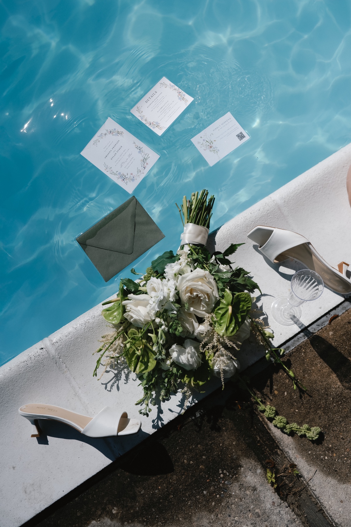 invites and bride style details in pool
