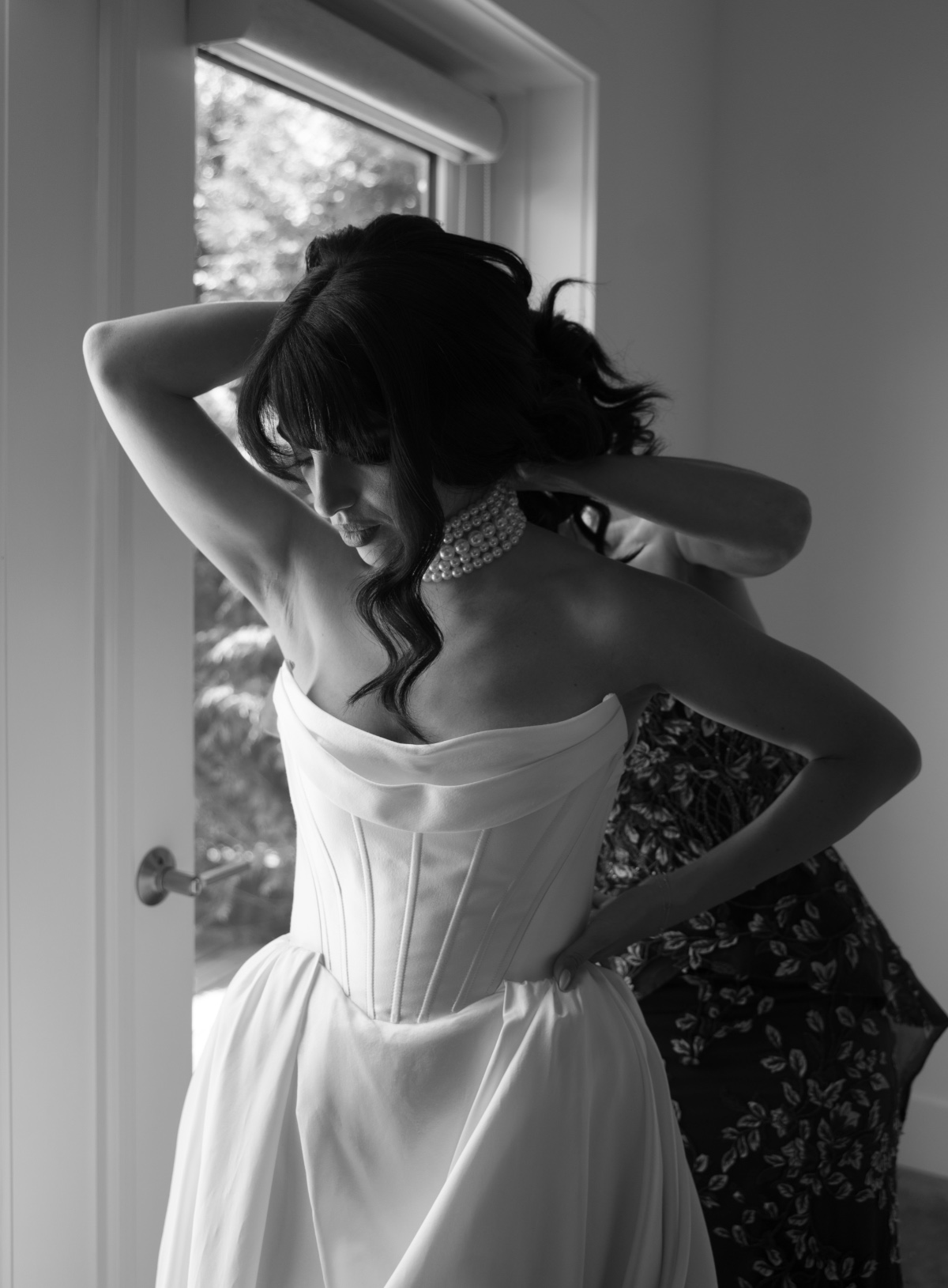 bride getting ready in black and white photo